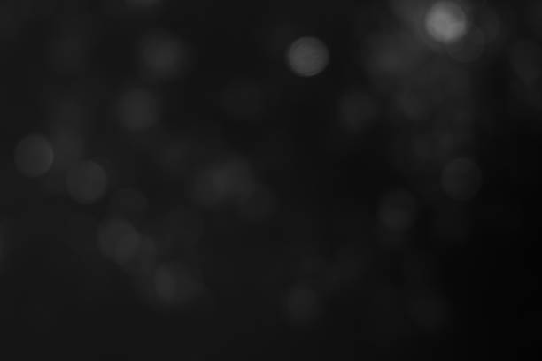 istock Dark blurred christmas lights background. Design effect focus happy holiday party glow texture black wallpaper bokeh sun sunny star shiny soft plain warm flare blur night light new year. 1287161130