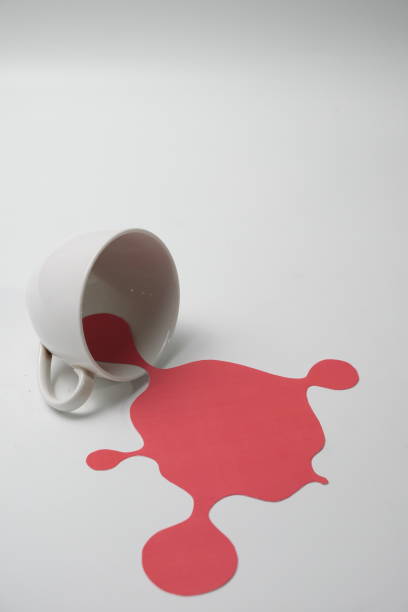 istock Red splash from white  glass on white background 1287163686