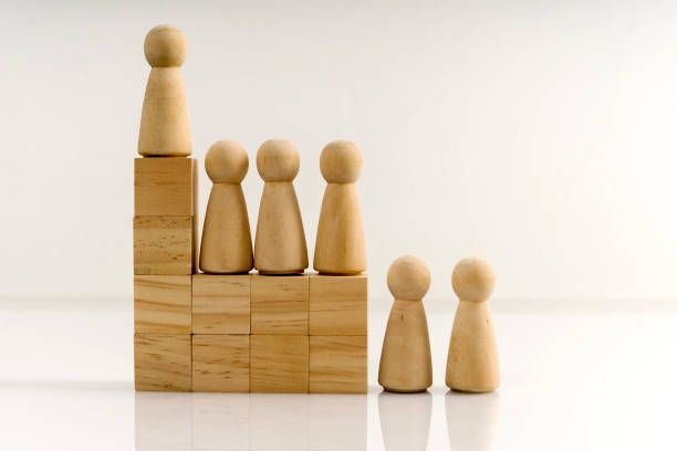 istock Wooden figures stand on the cubes that represent the stairs. 1287164474