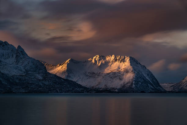 istock Snowcapped mountain range lightened by the first morning light in Steinfjord, Norway. 1287167116