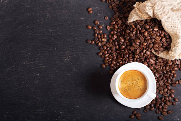 istock cup of coffee and coffee beans on dark background 1287169618
