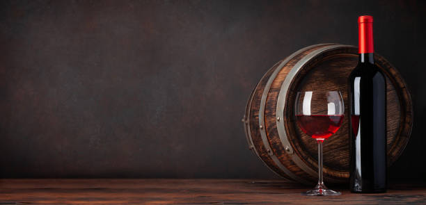 istock Wine bottle and old wooden barrel 1287170574