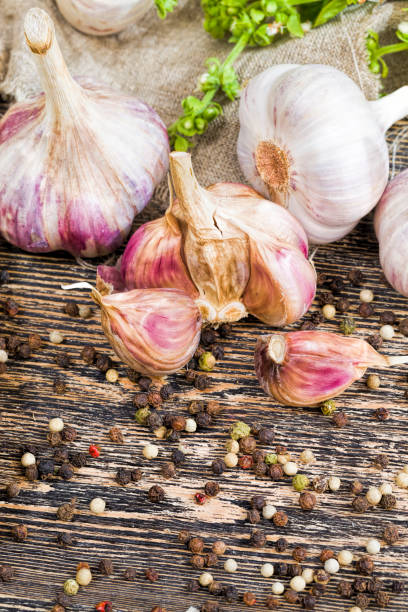 cloves of ripe garlic cloves of ripe garlic on the kitchen table while cooking a dish with garlic, sliced garlic on a cutting Board that is added to the food to give a pleasant taste Relish stock pictures, royalty-free photos & images