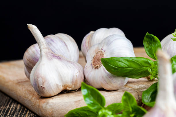 vegetables on the table vegetables on the table during cooking ripe garlic and green Basil vegetables and spices on the cutting Board close up Relish stock pictures, royalty-free photos & images