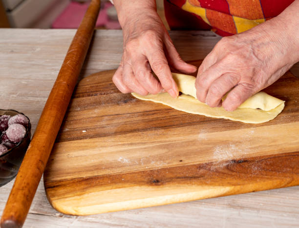 istock Woman preparing cherry sticks for pie Monastic hut  at home 1287172359