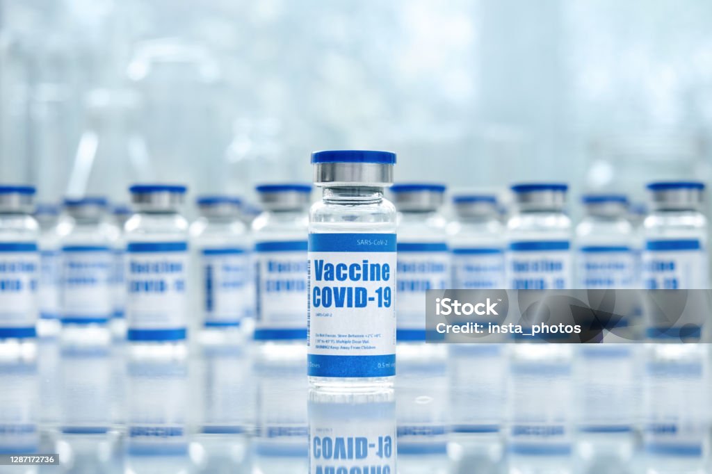Covid 19 corona virus vaccine vial bottles for intramuscular injections on medical pharmaceutical industry background. Coronavirus cure manufacture, flu treatment drug pharmacy production concept. COVID-19 Vaccine Stock Photo