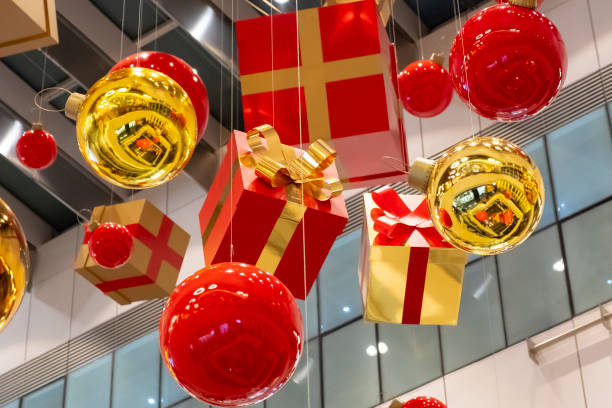 istock Christmas decorations red and golden baubles hanging down from ceiling. Winter festive decoration. Holiday celebration. 1287177093