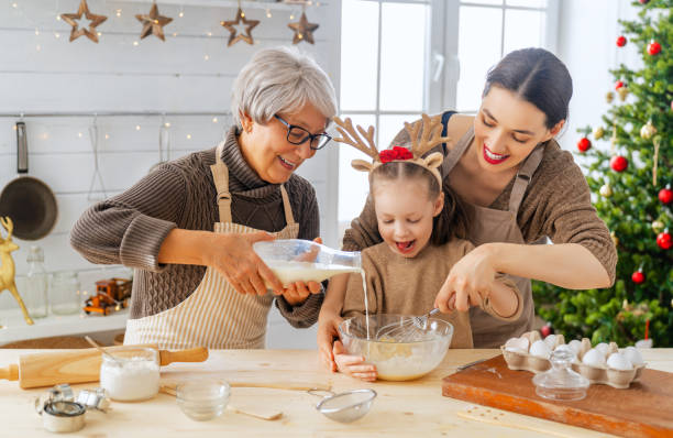 Cooking Christmas cookies Merry Christmas and Happy Holidays. Family preparation holiday food. Grandma, mother and daughter cooking cookies. baking stock pictures, royalty-free photos & images