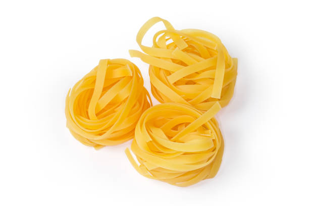istock Uncooked noodle coiled into nests on a white background 1287178830