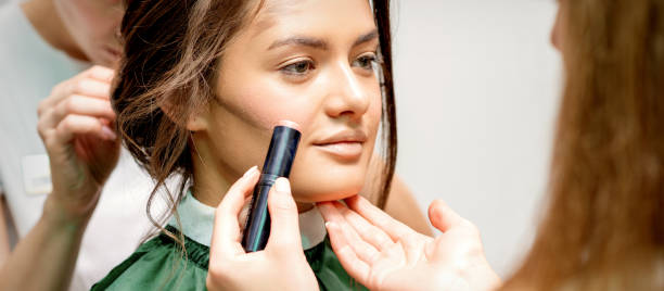 istock Makeup artist applying cream blush stick 1287178840