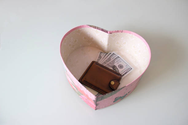 Wallet with money lies in a gift box. Wallet with money lies in a gift box. Beautiful heart gift for valentines day. valentinstag stock pictures, royalty-free photos & images