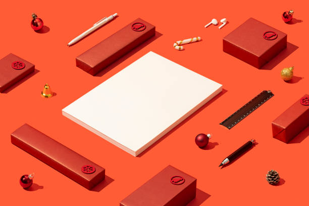 Blank white magazine cover mockup, template on red background with red gift boxes, Christmas ornament, pen, ruler and earphones