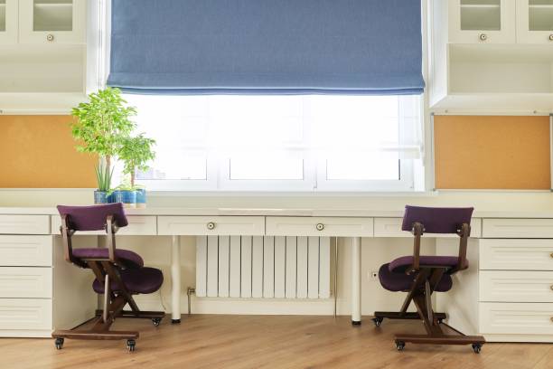 istock Home office, workplace for two people, desk near the window 1287181026