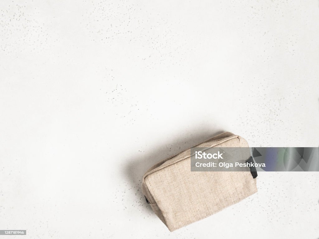 Eco textile cosmetic bag on grey background Eco textile cosmetic bag on grey background. top view. Copy space Make-Up Bag Stock Photo
