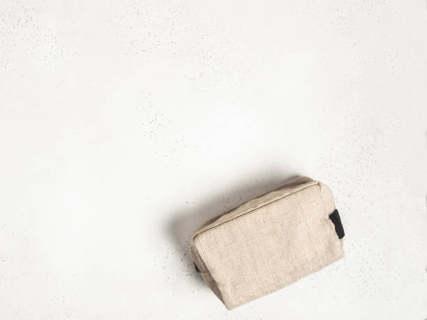 Eco textile cosmetic bag on grey background Eco textile cosmetic bag on grey background. top view. Copy space make up bag stock pictures, royalty-free photos & images