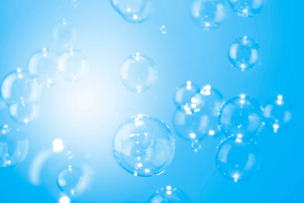 istock Abstract, Beautiful shiny transparent soap bubbles float on a blue texture background. Natural freshness summer holiday background. 1287182329