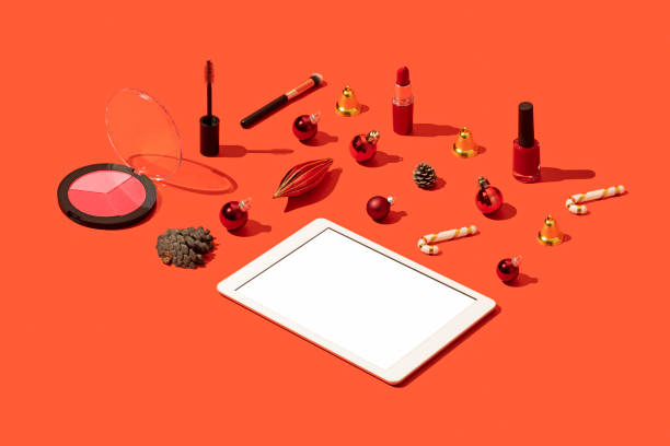 istock Digital tablet mockup with cosmetic flat lay on Christmas concept red background 1287183615