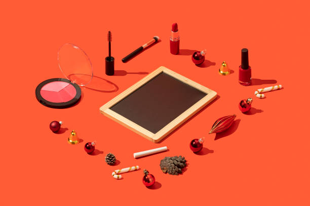 istock Christmas concept flat lay with blackboard template and makeup on red background 1287184579