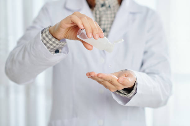 istock Doctor applying gel hand sanitizer 1287186101