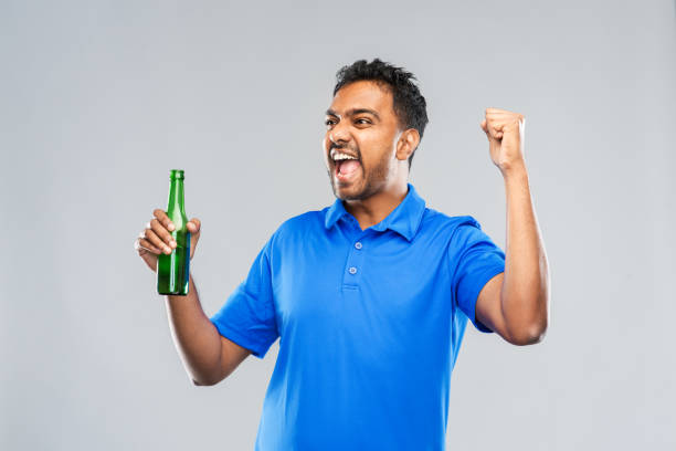istock male fan with beer bottle celebrating victory 1287186683