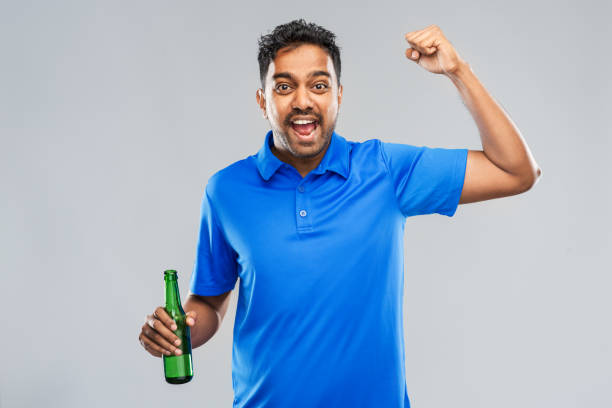 istock male fan with beer bottle celebrating victory 1287187418
