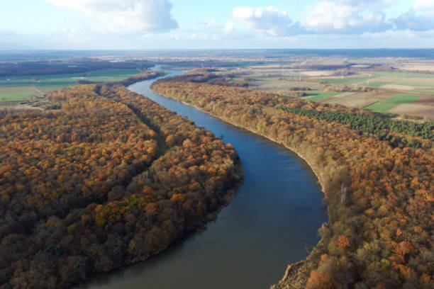 istock Yellow autumn forest and blue river, top view, autumn landscape 1287187830