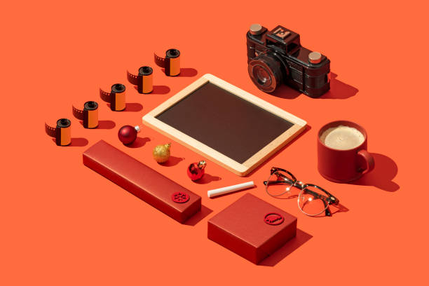 istock Blackboard mockup, template on red Christmas concept background with red gift box and photographic equipment 1287187878