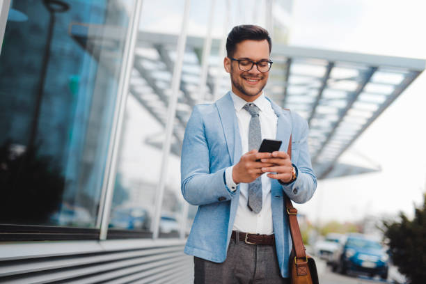 istock Handsome businessman messaging outdoor 1287188343