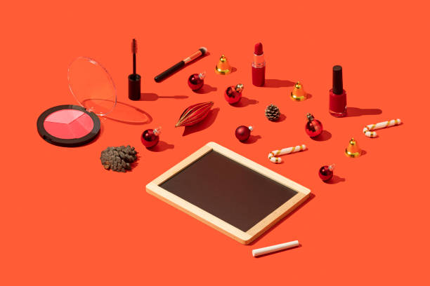 istock Christmas concept flat lay with blackboard template and makeup on red background 1287188416