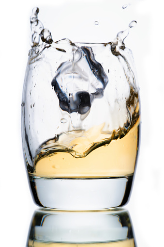 Pouring a glass of single malt Scotch whisky.