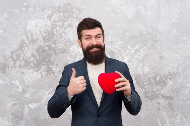 istock Excellent celebration ideas for low budget. Fall in love. Love and romance concept. Bearded man hold plush toy red heart. Happy valentines day. Celebrate love. Gift shop. Gentleman get ready for date 1287191669