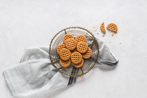 Crispy fresh cookies on delicate gray background, top view with copy space