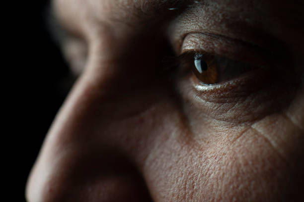 istock Portrait Of Man Against Black Background 1287193354