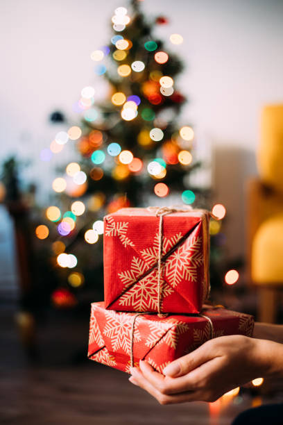 istock Hand Giving Christmas gift 1287196369