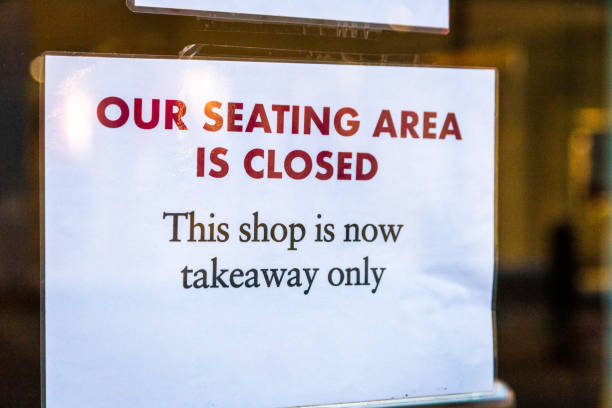 istock Closed sign in shop window 1287198153
