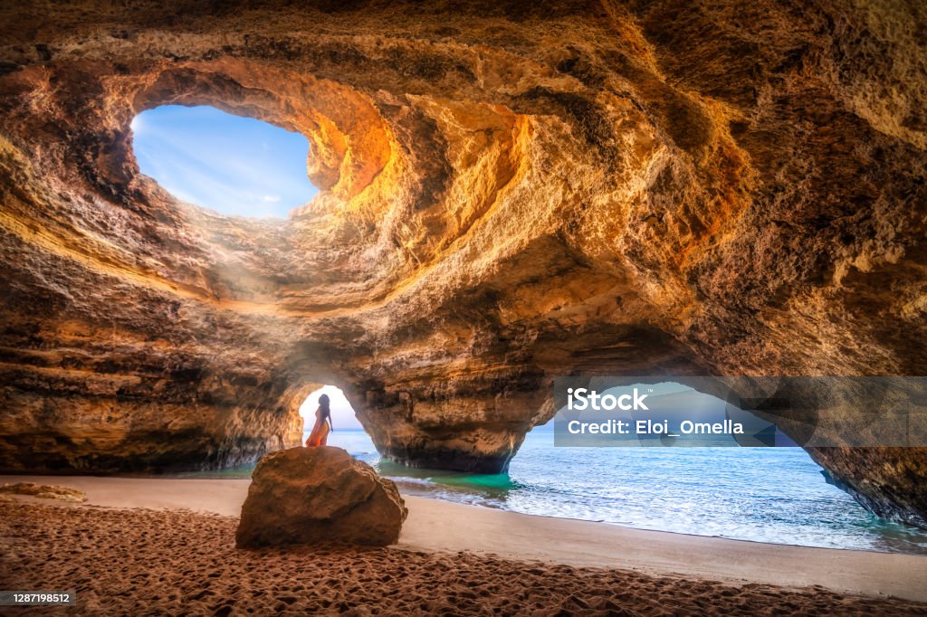 beatuful woman in Benagil Cave, Algarve, Portugal Woman alone under the sunlight in the natural Sea Cave of Benagil, Algarve, Portugal Algarve Stock Photo