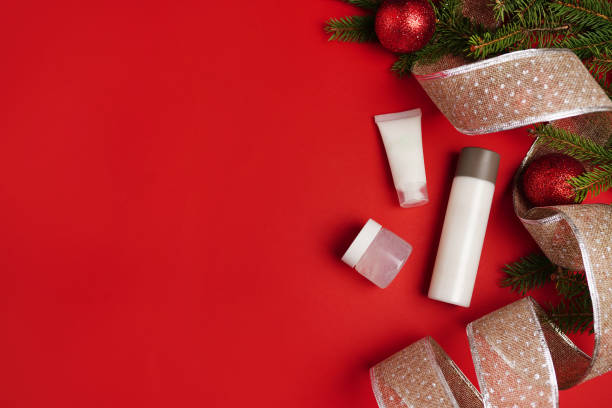 istock Set of cosmetic products on red background, flat lay. Winter care. copy space 1287200321