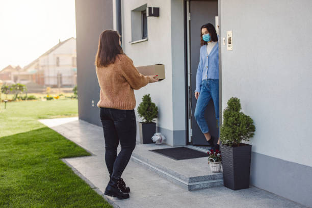 istock Young woman volunteering, bringing a care package to a friend in quarantine 1287200921