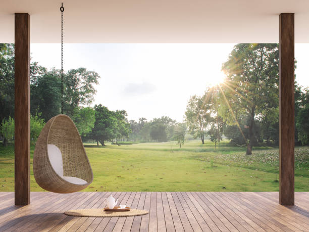 Wooden terrace with morning garden view 3d render Wooden terrace with morning garden view 3d render, There are wooden floor,Decorate with rattan egg shaped chair,looking out over the large lawn. building terrace stock pictures, royalty-free photos & images