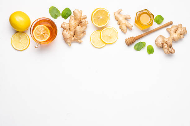 istock Hot tea with ginger, honey and lemon in glass cup. Immune system support with alternative medicine.  White background, Top view, Сopy space 1287201715