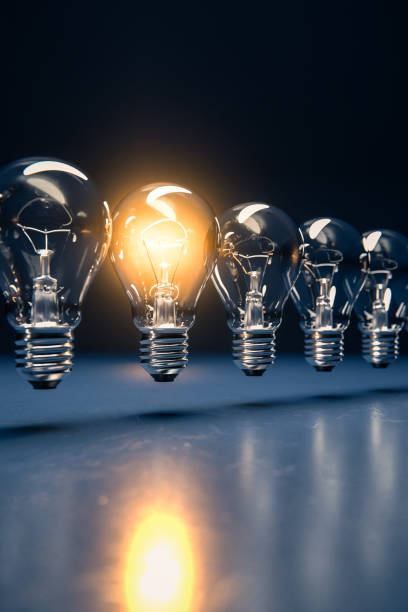 istock A row of lightbulbs with one brigthly lit - concept for having an idea, innovation, standing out. Diminshing perspective 1287202555