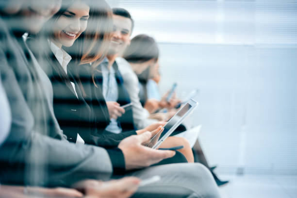 istock group of candidates filling out an interview form 1287203188