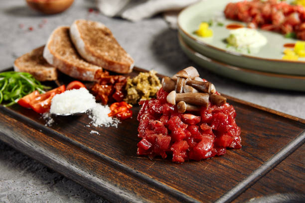istock Beef tartare on wooden plate 1287206922