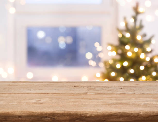 desk space in front of defocused window with christmas tree - close up shiny merchandise rough imagens e fotografias de stock