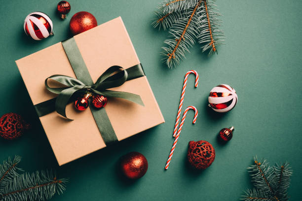 istock Vintage Christmas ornaments and gift box on dark green background. Flat lay, top view. 1287211607