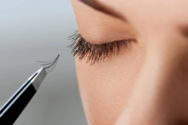istock Eyelash Extension Procedure. Woman Eye with Long Eyelashes. Lashes, close up, macro, selective focus.Cosmetics and makeup 1287212642