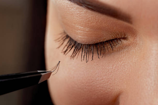 istock Eyelash Extension Procedure. Woman Eye with Long Eyelashes. Lashes, close up, macro, selective focus.Cosmetics and makeup 1287212659