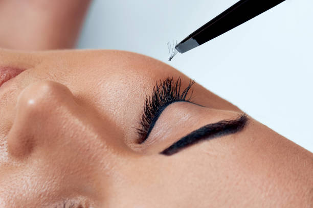 istock Eyelash Extension Procedure. Woman Eye with Long Eyelashes. Lashes, close up, macro, selective focus.Cosmetics and makeup. 1287212779