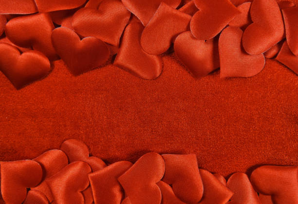 istock red hearts on red velvet  , copy space 1287212931