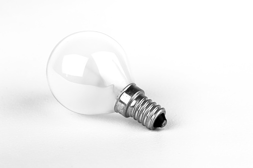 Vintage glass light bulb isolated on white background. Top view. minimal concept